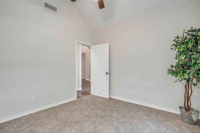 spare room with carpet floors, high vaulted ceiling, and ceiling fan