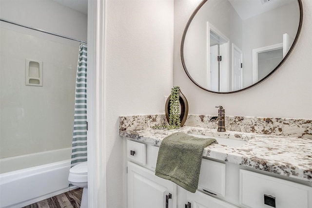 full bathroom with shower / bathtub combination with curtain, vanity, wood-type flooring, and toilet