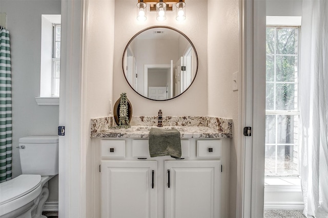 bathroom featuring vanity and toilet