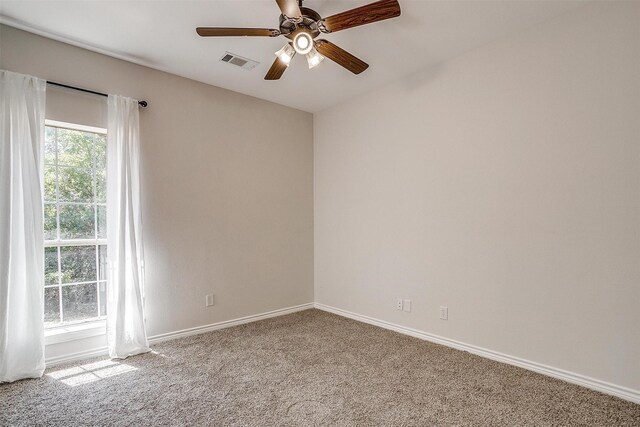 spare room featuring carpet flooring and ceiling fan