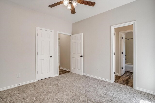 unfurnished bedroom with carpet, ceiling fan, and ensuite bathroom