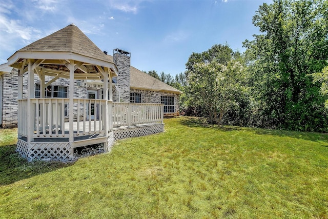 view of yard with a deck and a gazebo