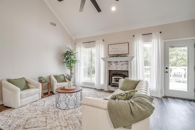 living room with a wealth of natural light, ceiling fan, lofted ceiling, and hardwood / wood-style flooring