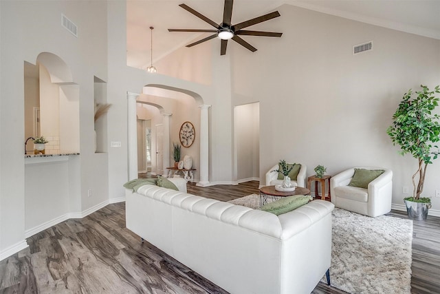 living room with ceiling fan, dark hardwood / wood-style flooring, and high vaulted ceiling