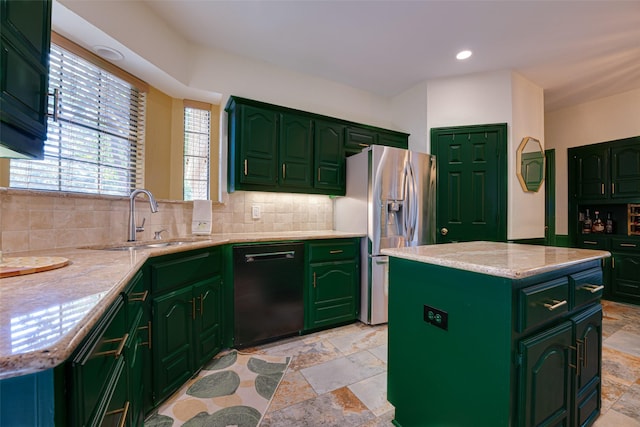 kitchen with dishwasher, sink, backsplash, stainless steel fridge, and a kitchen island