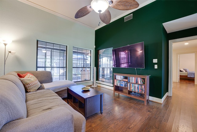 living room featuring dark hardwood / wood-style flooring, ceiling fan, and ornamental molding