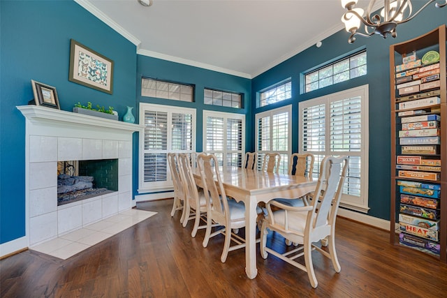 dining space with a fireplace, a healthy amount of sunlight, dark hardwood / wood-style floors, and ornamental molding