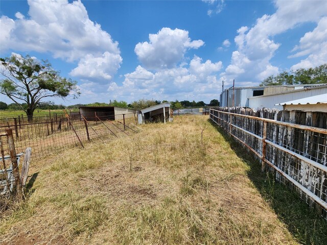 view of yard with a rural view