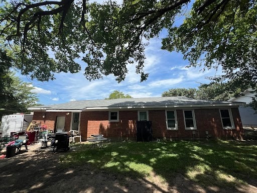 back of house with a lawn