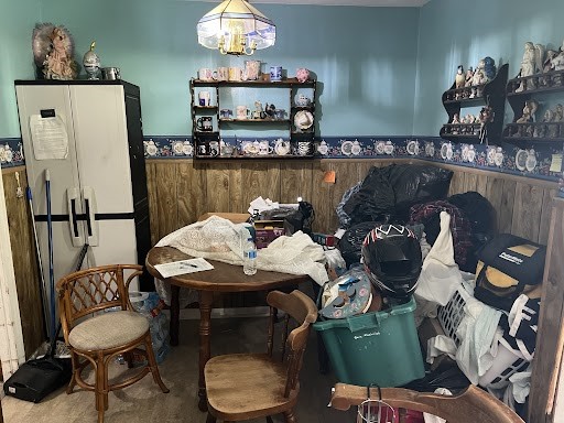 miscellaneous room with carpet floors and a chandelier