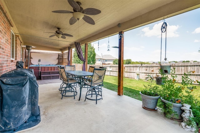 view of patio / terrace with ceiling fan and a hot tub