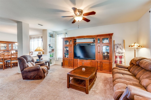 living room with light colored carpet and ceiling fan