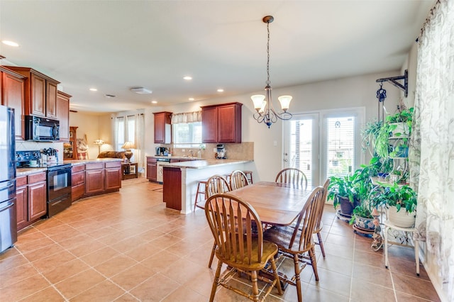 dining space featuring a notable chandelier and light tile patterned floors