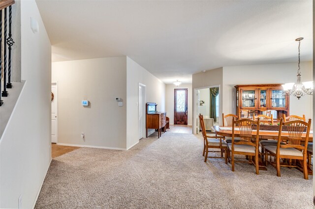 entryway featuring ceiling fan and light carpet