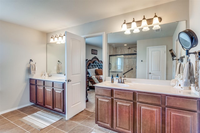 bathroom featuring tile patterned flooring, vanity, and a shower with shower door