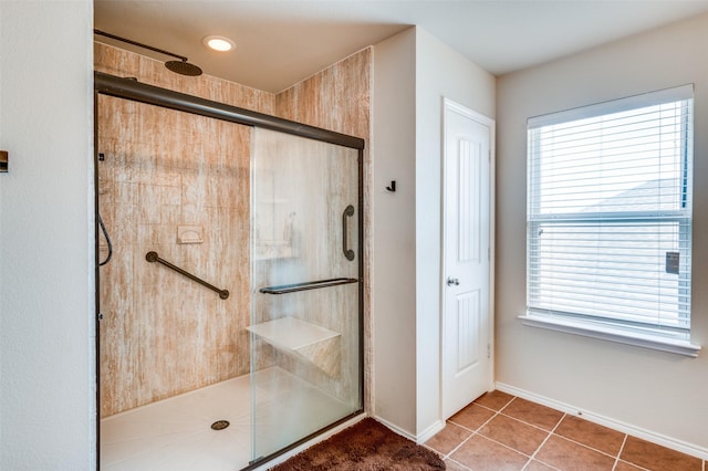 bathroom featuring tile patterned floors and a shower with shower door