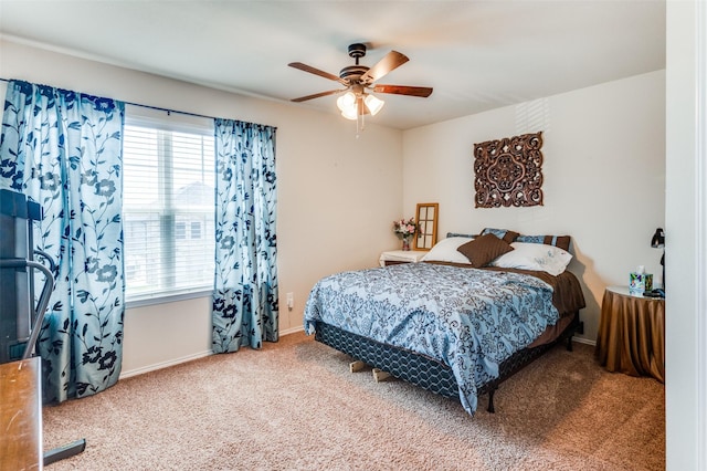 carpeted bedroom featuring ceiling fan and multiple windows