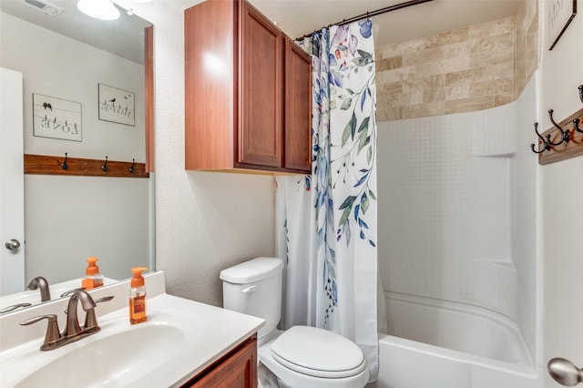 full bathroom with vanity, shower / tub combo, and toilet