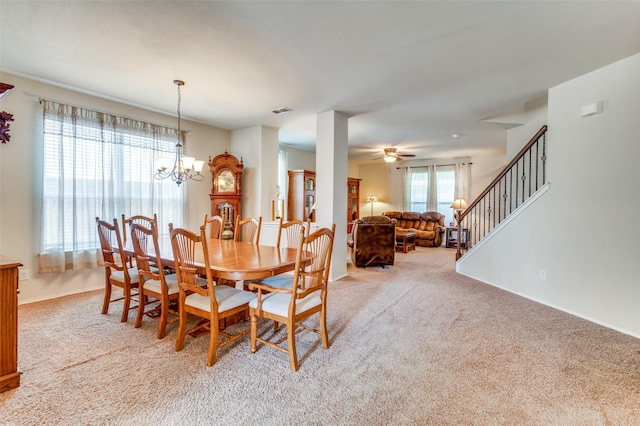 carpeted dining area with a notable chandelier