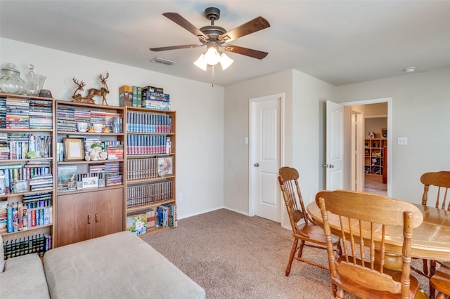 dining room with ceiling fan and carpet flooring