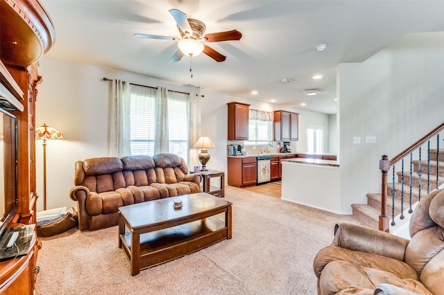 carpeted living room featuring ceiling fan