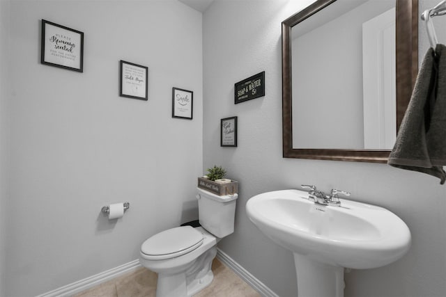 bathroom featuring toilet and tile patterned flooring