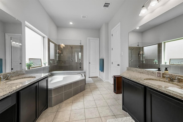 bathroom with tile patterned flooring, vanity, and shower with separate bathtub