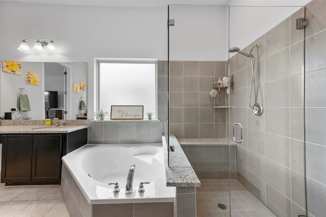 bathroom featuring shower with separate bathtub, tile patterned flooring, and vanity