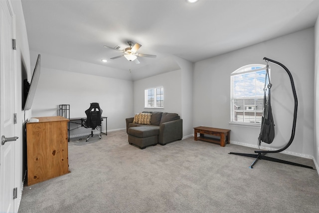 carpeted office space with ceiling fan