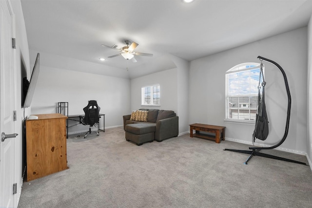 sitting room with plenty of natural light, light carpet, and ceiling fan