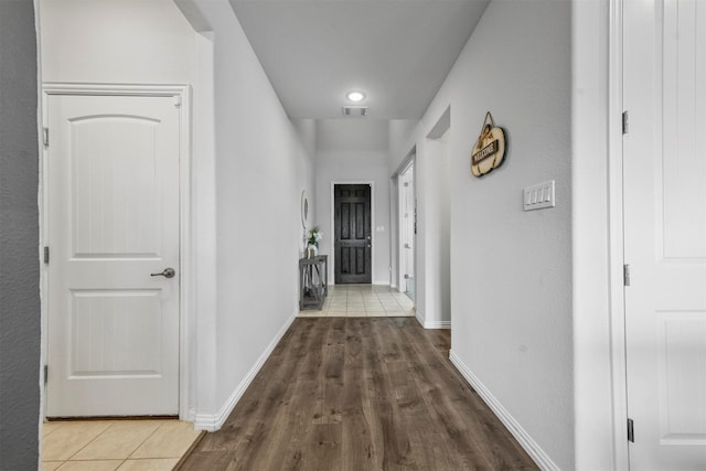 corridor featuring dark tile patterned flooring