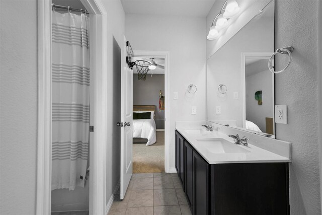 bathroom featuring tile patterned flooring and dual bowl vanity