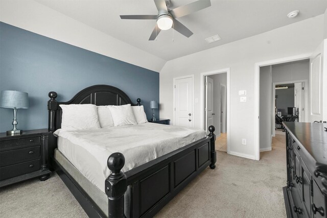 bedroom featuring vaulted ceiling, ceiling fan, and light colored carpet