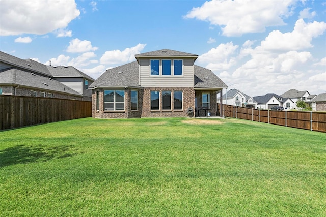 back of house featuring a yard