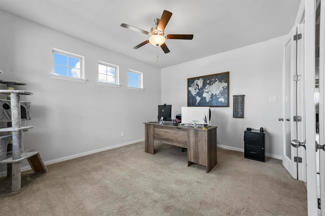 carpeted office space with ceiling fan