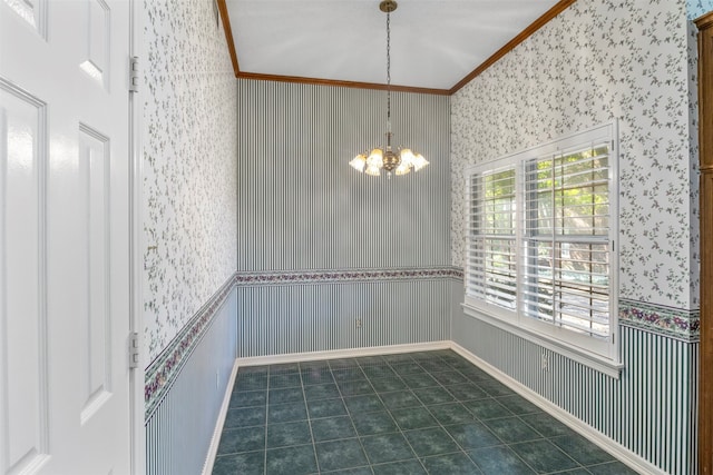 unfurnished dining area featuring ornamental molding, dark tile patterned flooring, and a chandelier