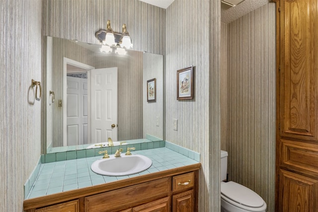 bathroom with vanity, a chandelier, and toilet