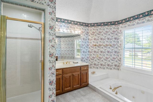 bathroom with plenty of natural light, vanity, and independent shower and bath