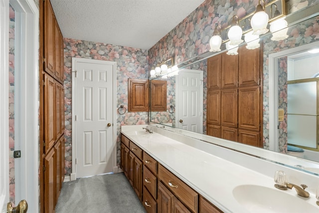 bathroom with vanity and a textured ceiling