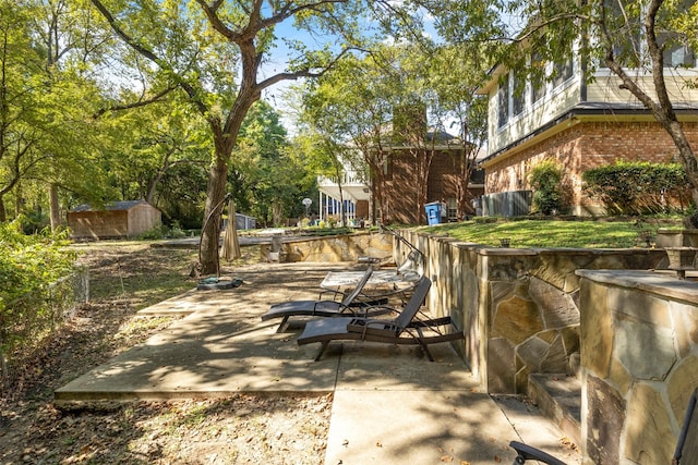 view of patio / terrace with a shed