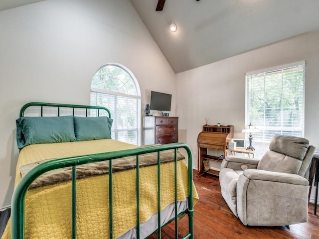 bedroom featuring dark hardwood / wood-style flooring, high vaulted ceiling, and ceiling fan