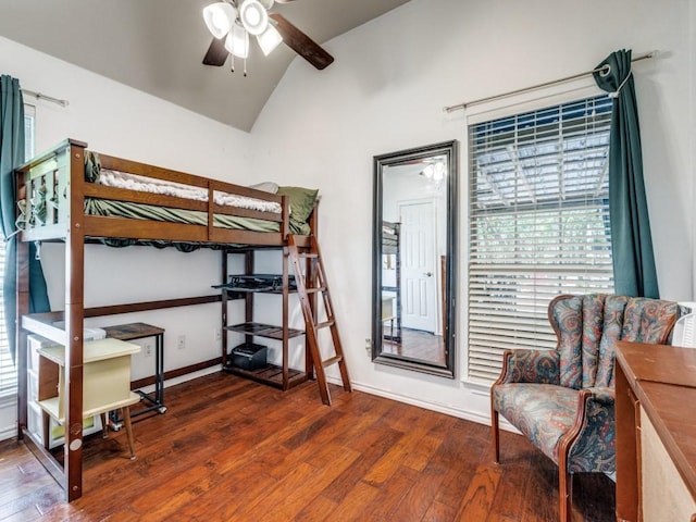 bedroom with dark wood-type flooring and lofted ceiling