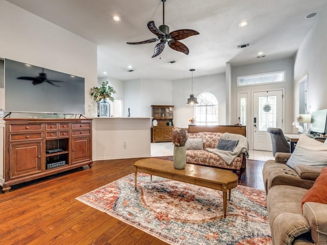 living room featuring hardwood / wood-style floors and ceiling fan