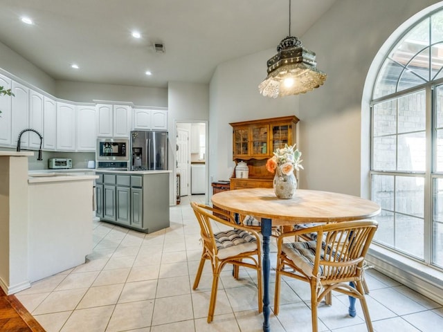 dining space with sink and light tile patterned floors