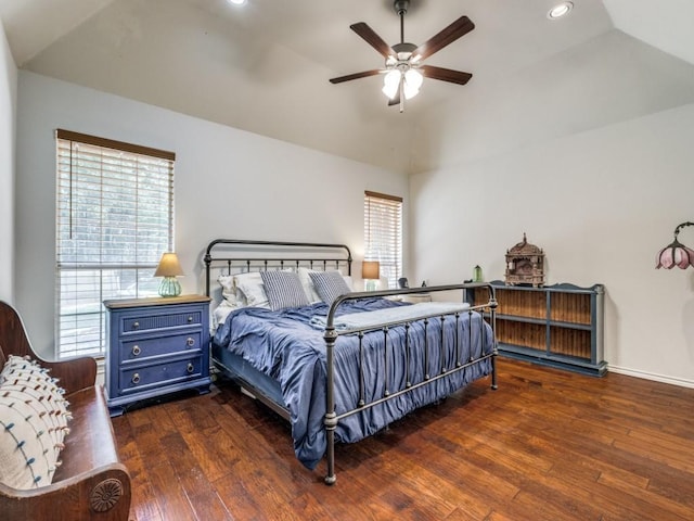 bedroom with multiple windows, vaulted ceiling, and dark hardwood / wood-style flooring