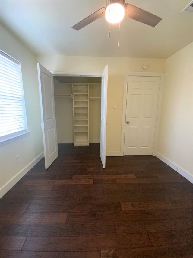 unfurnished bedroom featuring a closet, ceiling fan, and dark hardwood / wood-style flooring