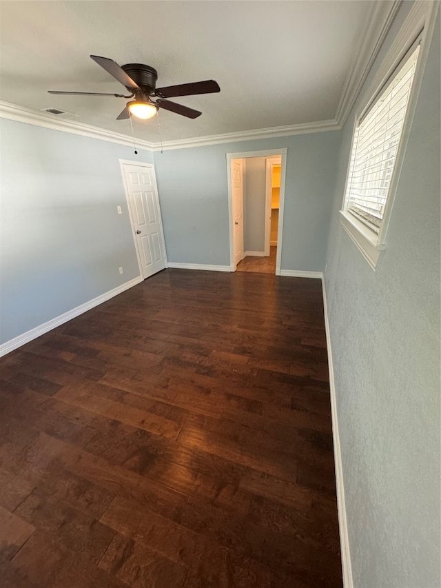 unfurnished bedroom with ceiling fan, dark wood-type flooring, and crown molding