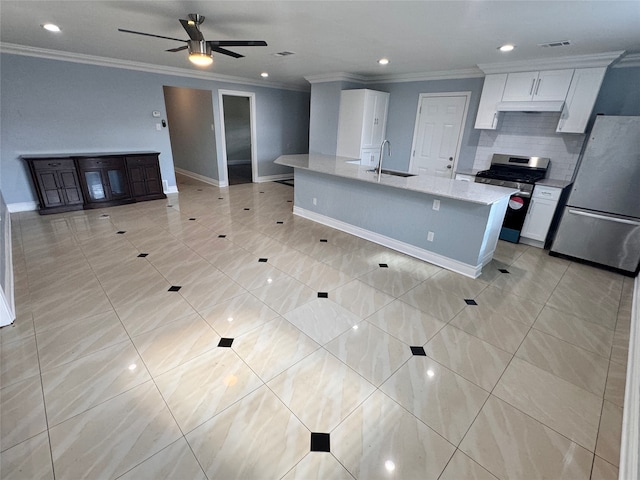 kitchen with appliances with stainless steel finishes, sink, white cabinets, light tile patterned floors, and ceiling fan