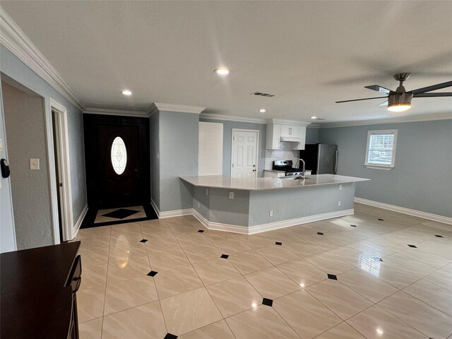 kitchen with white cabinetry, stainless steel appliances, light tile patterned flooring, and ceiling fan