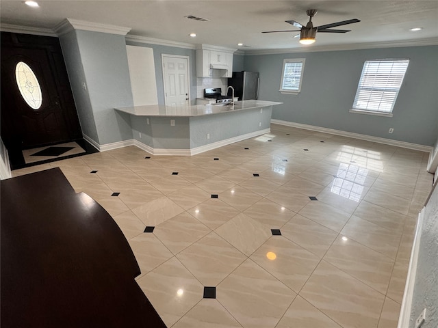 kitchen with kitchen peninsula, ceiling fan, white cabinets, and light tile patterned floors